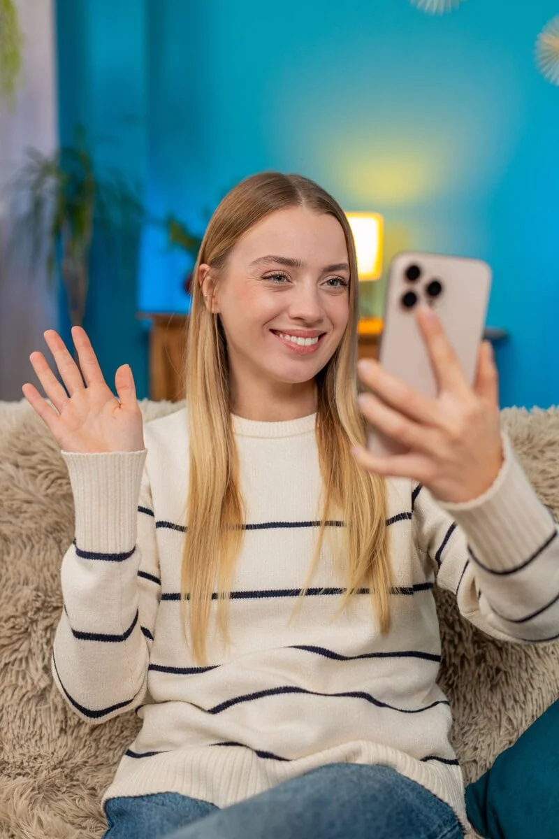 A smiling client on a video call from home during online depression counseling