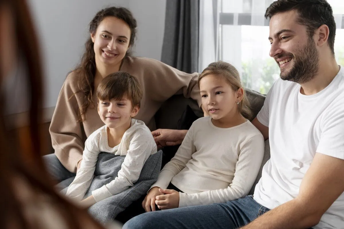 A family together in a familiar home environment during trauma-informed counseling