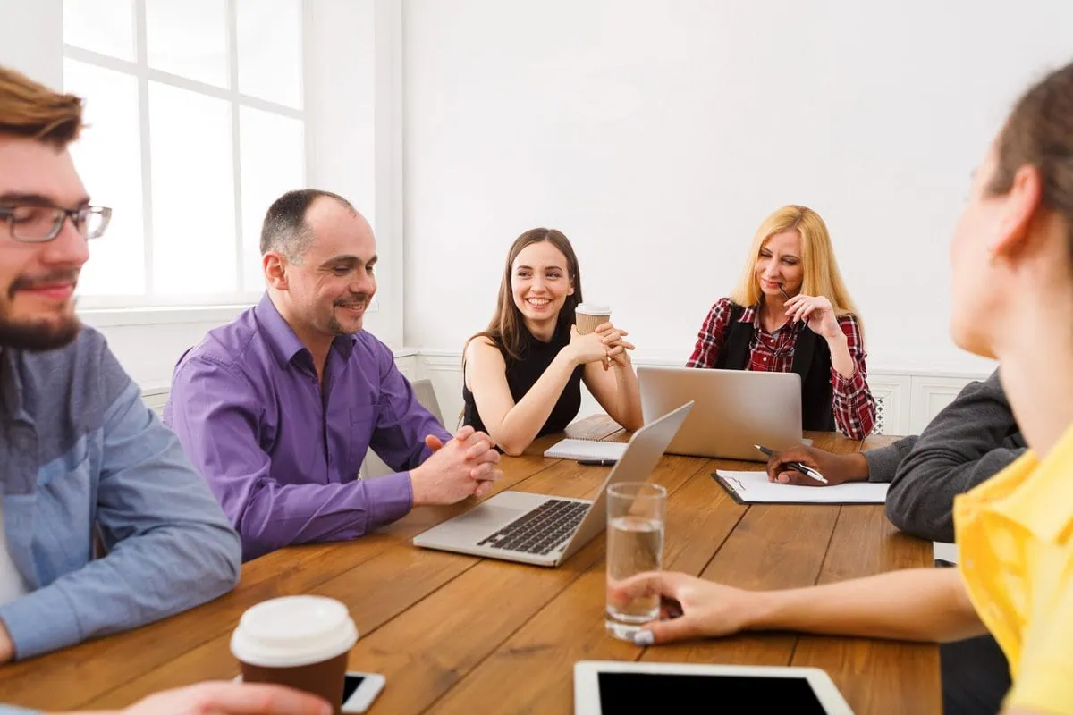 A multiethnic team collaborating around a table in an office meeting